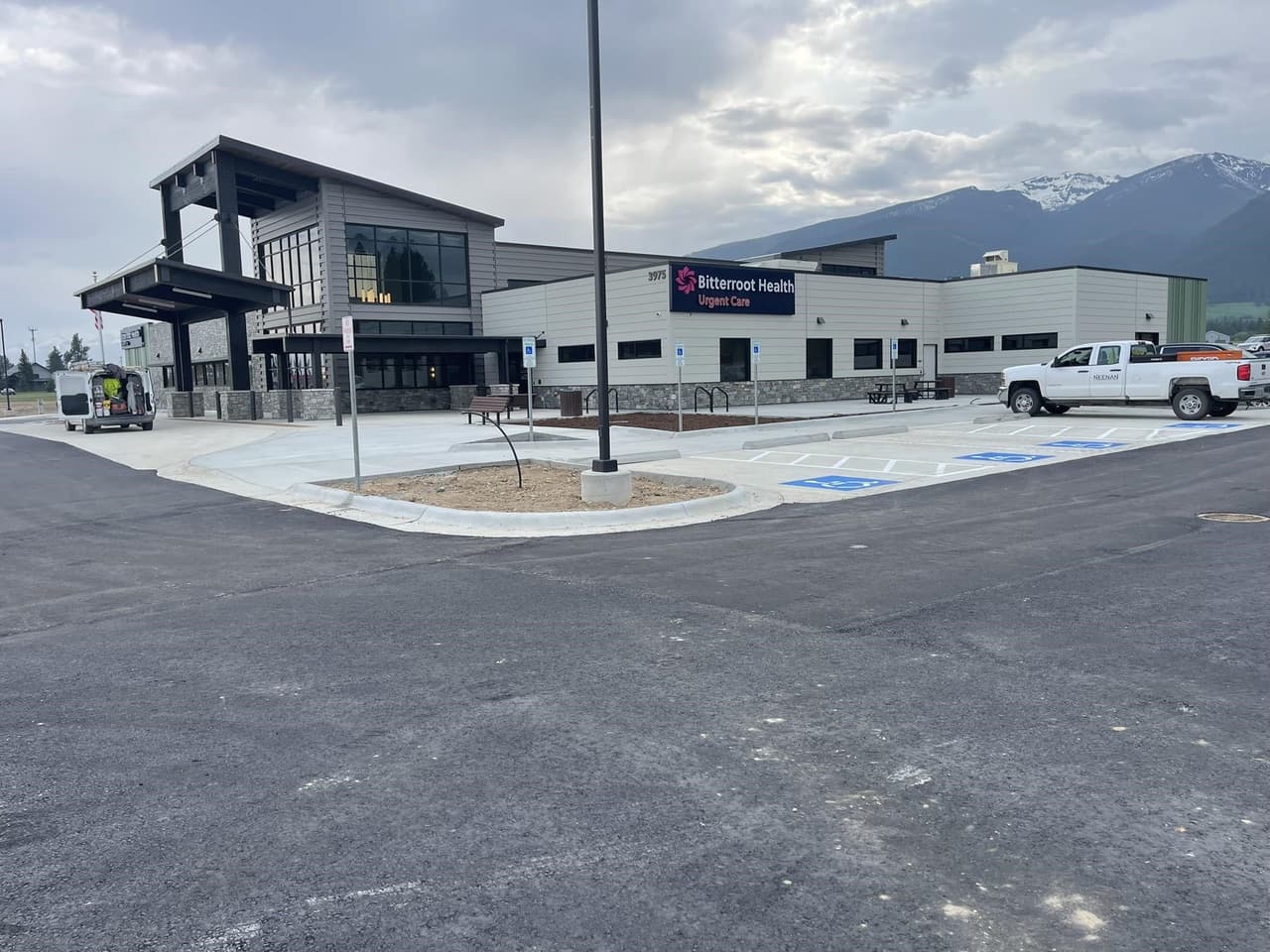 Paved commercial parking area with concrete approaches near the mountains